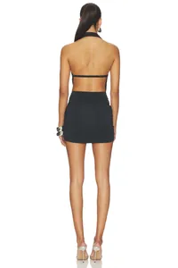 Rear view of a sexy black halter neck backless mini dress featuring elegant ruching details
