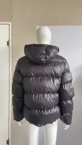 Macro view of the back of a men's quilted puffer jacket highlighting the hooded design