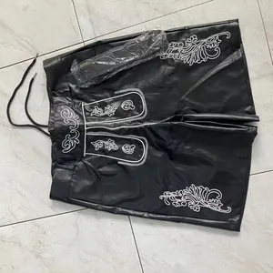 Detailed view of men's black Oktoberfest shorts with traditional white embroidery and belt