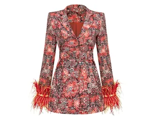 Detail view of red floral blazer dress featuring elegant feather cuffs and belted waist