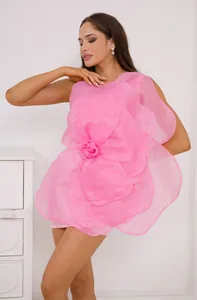 Detail view of a stunning pink one-shoulder dress with a large decorative 3D flower