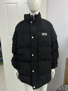 Full detail view of a black corduroy puffer jacket for men with a stand collar