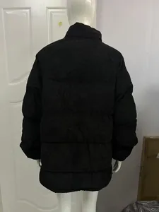 Back view of a black corduroy puffer jacket for men, warm minimalist winter style.