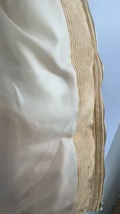 Close-up view showing the smooth inner lining and textured corduroy fabric of a puffer jacket