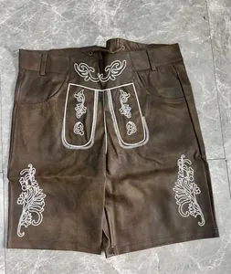 Detail view of traditional German Oktoberfest brown Lederhosen with white embroidery.