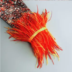 Close-up of vibrant orange-red feather trim used for elegant dress cuff decoration details