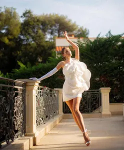 Elegant white one-shoulder mini dress with oversized 3D flower detail for parties.