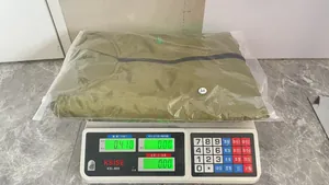 Weight measurement of a men's green flight jacket showing 0.410kg on scale