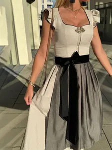 Detailed view of elegant Oktoberfest Dirndl dress with ruffle sleeves and black bow belt