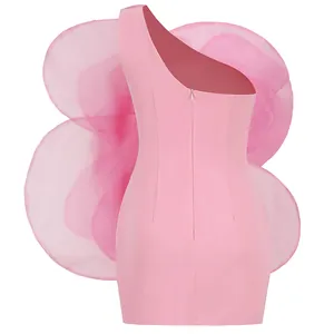 Back view of a high-end pink one-shoulder party dress featuring large organza ruffles