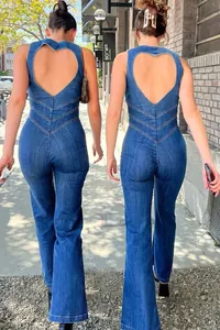 Back view of a sleeveless denim jumpsuit with heart-shaped cutout and retro flared legs.