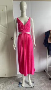 Detailed view of a hot pink V-neck sleeveless pleated dress featuring stylish waist cut-outs