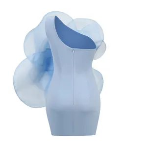 Back view of light blue one-shoulder mini dress featuring an oversized decorative flower.
