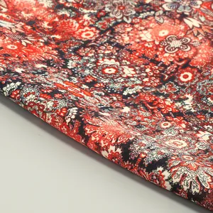 Close-up of elegant floral pattern fabric with intricate red and white ethnic motifs