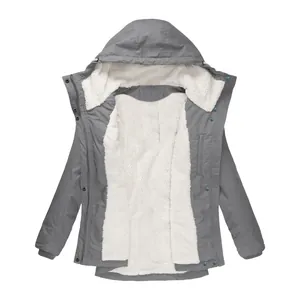 Detailed view of a grey women's hooded winter coat featuring soft white fleece lining