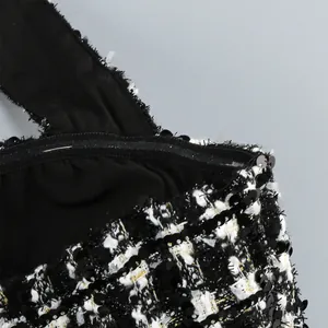 Detalle de cerca de la tela de tweed a cuadros en blanco y negro con lentejuelas