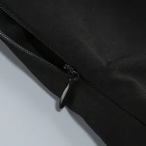 Detailed view of the invisible back zipper mechanism on a sexy black halter neck mini dress