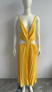 Detailed view of an elegant yellow V-neck pleated dress featuring stylish waist cut-outs
