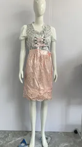 Detailed full view of traditional German Oktoberfest Dirndl dress with pink lace apron