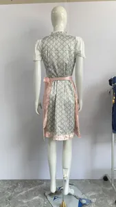 Back view of traditional German Oktoberfest dirndl dress with pink apron and lace details