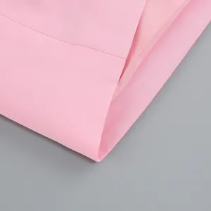 Close-up macro shot of the premium pink fabric texture for women's elegant evening dress