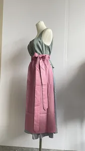 Detailed side profile of a traditional German Dirndl dress with a pink apron and grey top