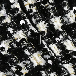 Primer plano de tela de tweed a cuadros en blanco y negro con lentejuelas y cremallera.