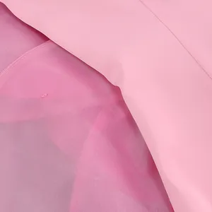 Detailed macro view showing the high-quality pink fabric and mesh lining of a party dress