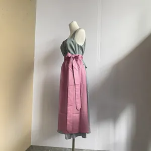 Traditional German Dirndl beer festival dress with grey sleeveless top and pink apron