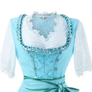 Detail of traditional light blue Oktoberfest dirndl with elegant white lace sleeves