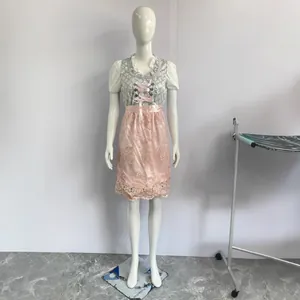 Plus size German Oktoberfest Dirndl costume dress with pink lace apron on mannequin