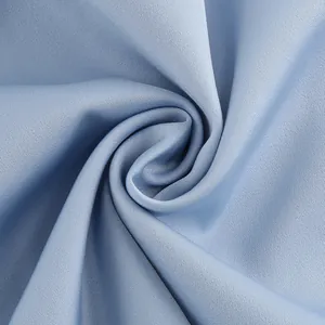 Macro view showing the elegant drape and fine texture of light blue satin fabric details