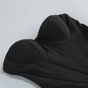 Close-up detail of a black corset top featuring structured boning and bustier cups.