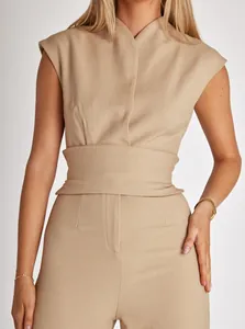 Close-up detail of a professional sleeveless beige wide-leg jumpsuit for women.