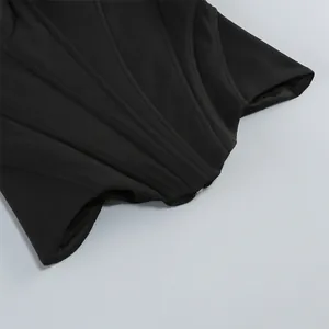 Detail of black corset top with fishbone waist-cinching structure and smooth fabric texture