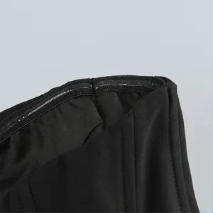 Close-up of the non-slip silicone strip and fabric detail on a black strapless top