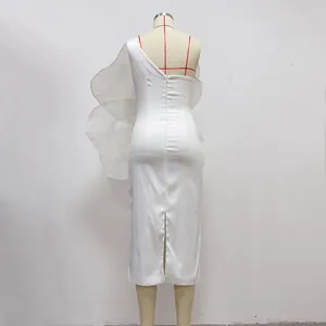 Detailed back view of elegant white one-shoulder dress with large floral ruffle