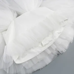 Detailed close-up showing the layers and texture of a white tiered tulle mesh puff tutu skirt