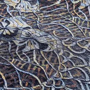 High-resolution macro detail of intricate shimmering lace fabric with golden floral patterns