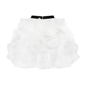Detailed front view of a white ruffled tulle bubble skirt with contrast black waistband