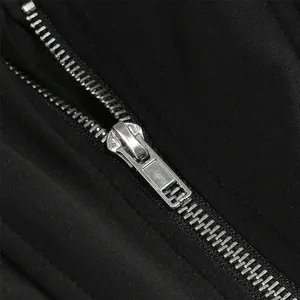 Macro view of high-quality silver metal zipper on black mesh puffed skirt detail