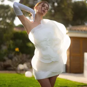 Elegant white one-shoulder mini dress with a large sculptural flower decoration