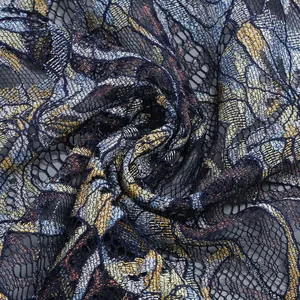 Close-up macro detail of intricate metallic lace fabric with floral embroidery patterns