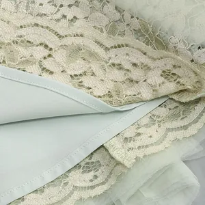 Detailed close-up showing fine stitching on mint green lace and pleated tulle fabric layers