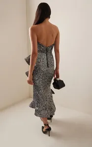 Detailed back view of an elegant silver sequin strapless midi dress with a ruffle hemline