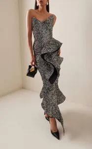Detailed view of a silver sequin strapless midi dress featuring a stylish ruffled hem.