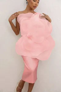 Detail of a pink party dress featuring a giant 3D mesh floral decoration on the front