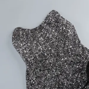 Close-up detail of shimmering black silver sequins on a strapless cocktail dress