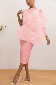 Detailed view of the large 3D fabric flower on the pink one-shoulder cocktail midi dress.