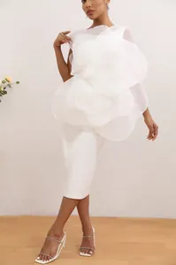 Elegant detail of a white one-shoulder party dress with an oversized organza flower